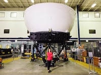 France Hébert, the Division President of Defense & Security Canada and Global Operations Lead at CAE, A former CAF officer and Professional Engineer. Outside a flight simulator in Montreal, July 10.