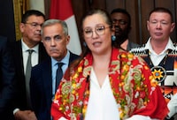 Prime Minister Mark Carney listens as Minister of Indigenous Services Mandy Gull-Masty speaks at a news conference in the House of Commons after Bill C-5 passed in the House in June. 