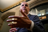 Prime Minister Mark Carney speaks with reporters yesterday in Ottawa.